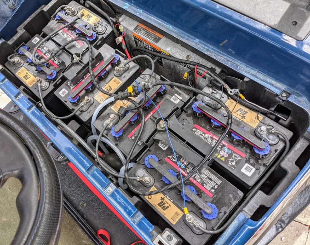 Old lead-acid batteries installed in a golf cart